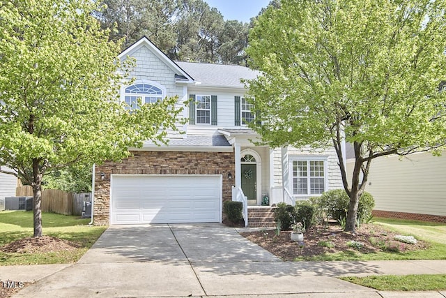 view of front facade featuring a garage, fence, a front lawn, a shingled roof, and driveway