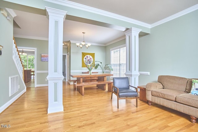 living room with visible vents, baseboards, ornamental molding, decorative columns, and light wood-style floors