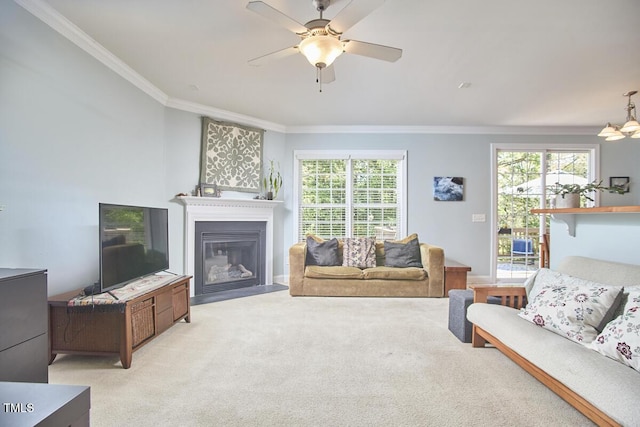 living room with light carpet, plenty of natural light, crown molding, and a ceiling fan
