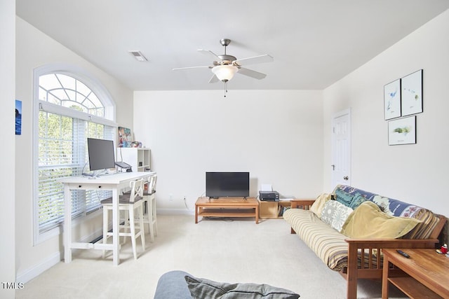 carpeted living area featuring visible vents, baseboards, and a ceiling fan