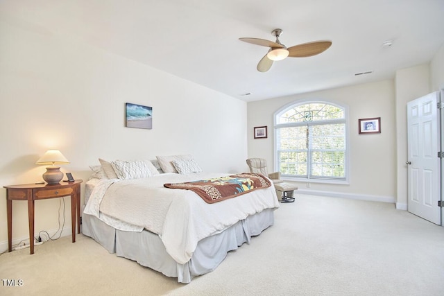 bedroom with light carpet, visible vents, baseboards, and ceiling fan