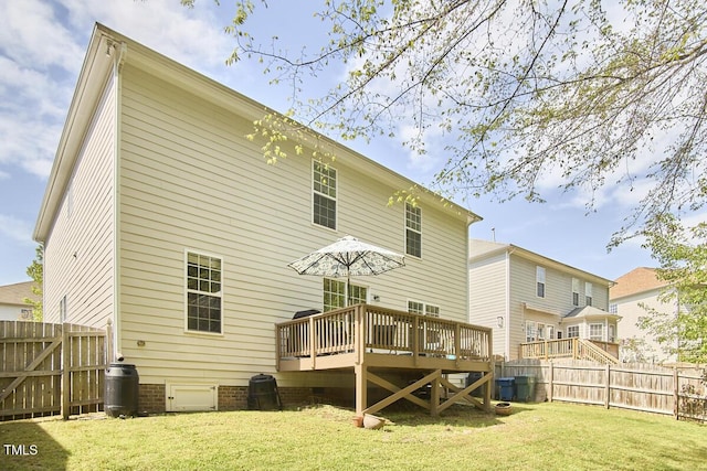 back of property featuring a fenced backyard, a wooden deck, a lawn, and crawl space