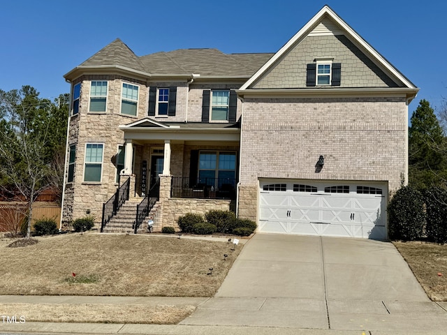 view of front of home featuring driveway, a garage, stone siding, a porch, and brick siding