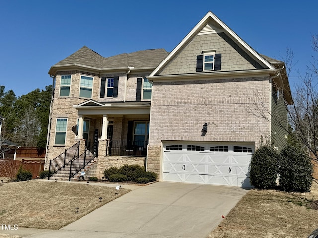 craftsman-style home featuring a garage, covered porch, concrete driveway, and brick siding