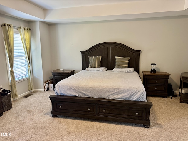 bedroom featuring visible vents, baseboards, and light colored carpet