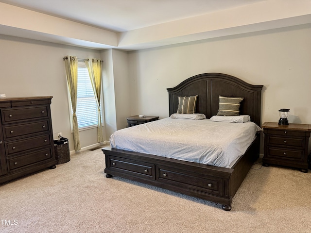 bedroom with light carpet and baseboards