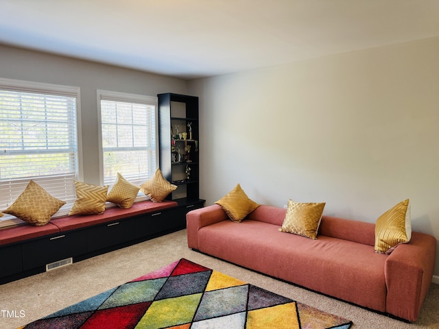 living area with carpet floors and visible vents