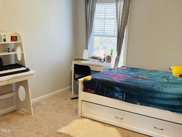 bedroom with baseboards and light colored carpet