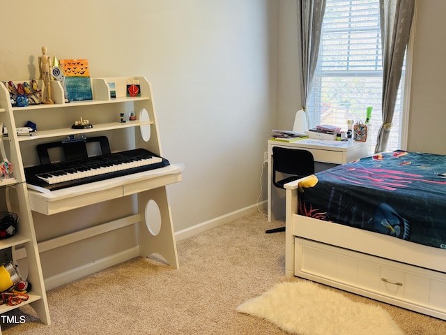 bedroom with baseboards and light colored carpet