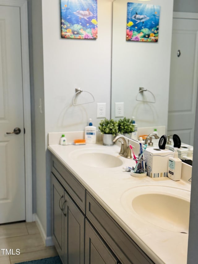 bathroom featuring a sink and double vanity