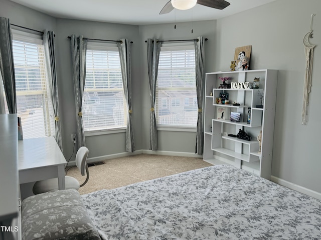 carpeted office space featuring a healthy amount of sunlight, visible vents, and baseboards