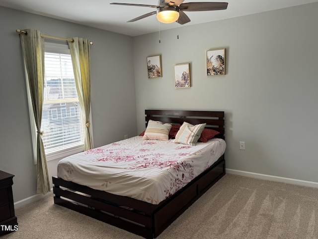 bedroom featuring carpet floors, a ceiling fan, and baseboards