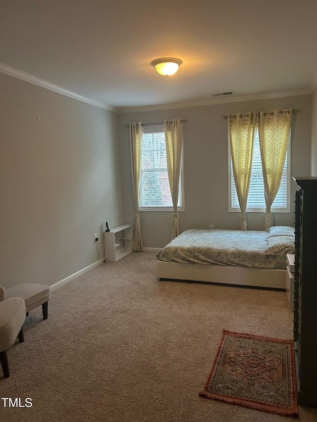 bedroom with ornamental molding, carpet flooring, visible vents, and baseboards