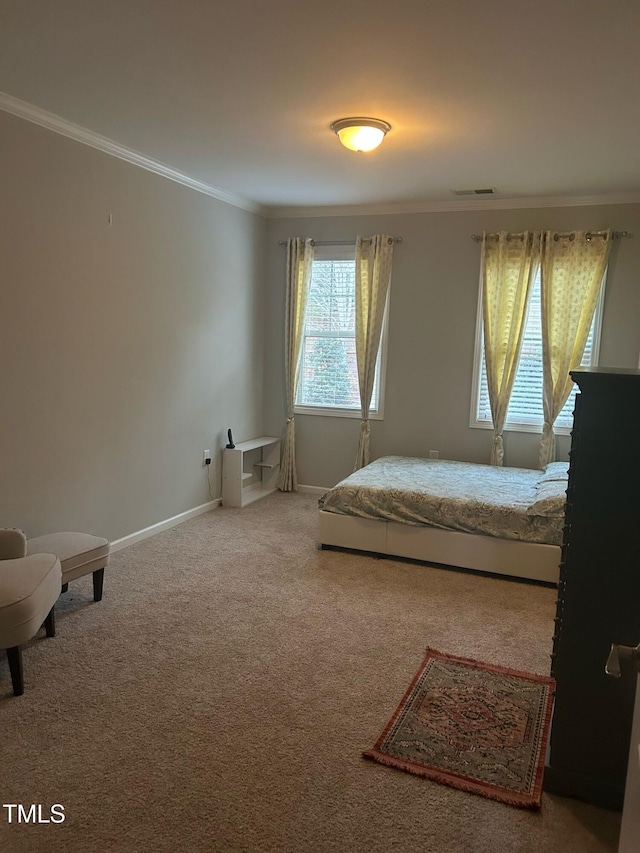 bedroom with ornamental molding, carpet, visible vents, and baseboards