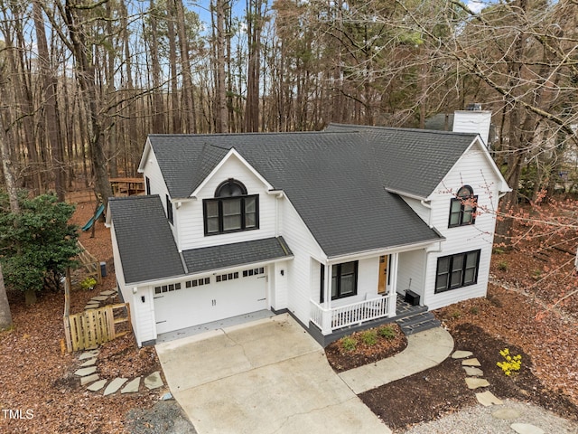 modern inspired farmhouse featuring a porch, concrete driveway, a chimney, and a shingled roof