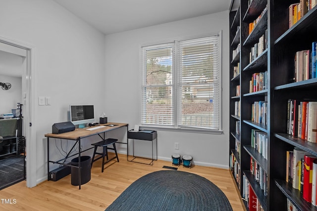 office space featuring baseboards and wood finished floors