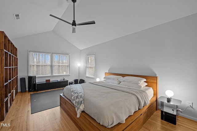 bedroom with lofted ceiling, light wood-style flooring, visible vents, and ceiling fan