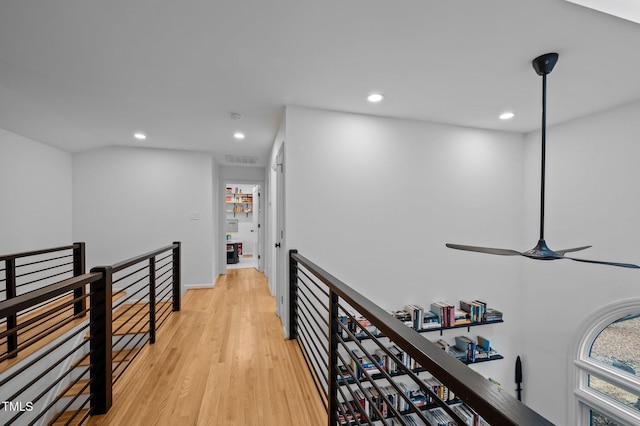 hall featuring visible vents, baseboards, recessed lighting, an upstairs landing, and light wood-type flooring