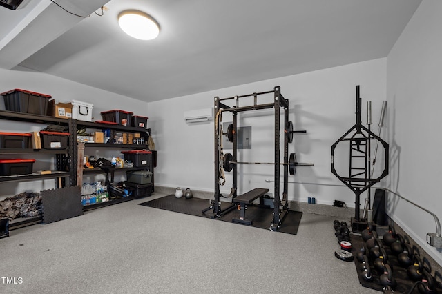 workout area with baseboards and a wall unit AC