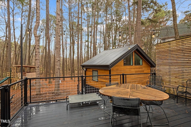 wooden terrace with outdoor dining area