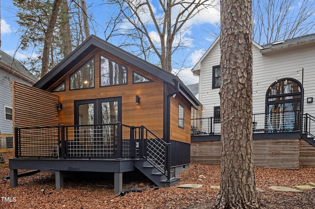 back of house with a deck and french doors