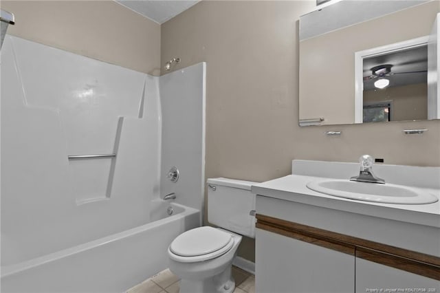 full bath with toilet, a ceiling fan, vanity, tub / shower combination, and tile patterned floors