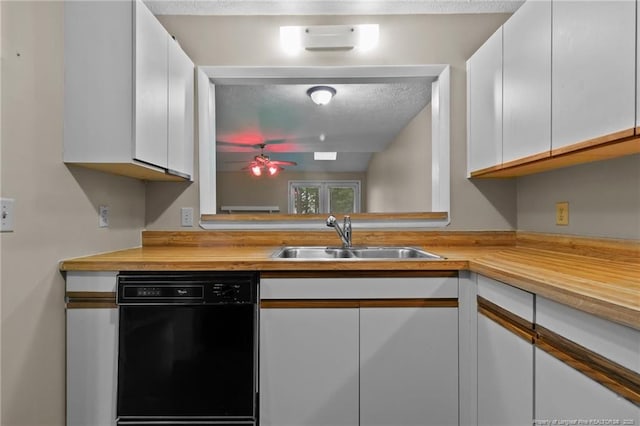 kitchen featuring ceiling fan, a textured ceiling, a sink, white cabinets, and black dishwasher