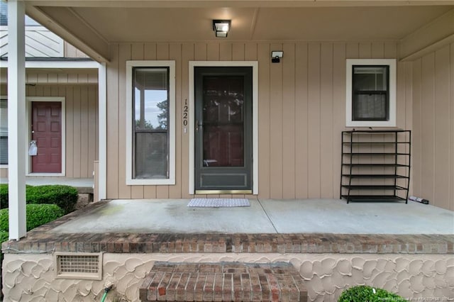 property entrance with visible vents and a porch