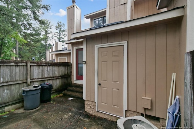 exterior space featuring entry steps, central AC, and fence