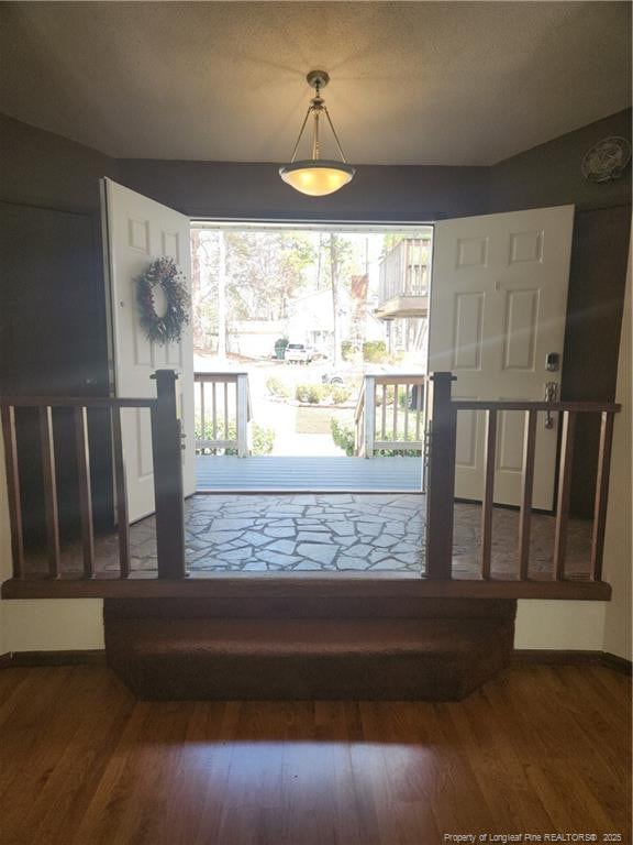 doorway to outside with wood finished floors