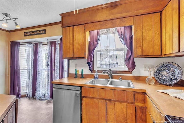 kitchen featuring brown cabinets, light countertops, a sink, a textured ceiling, and dishwasher