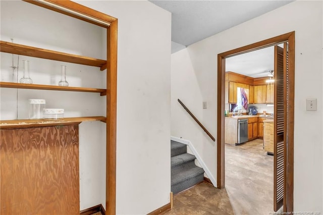 staircase with concrete floors and baseboards