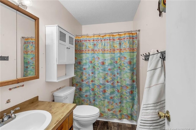 full bathroom with a textured ceiling, toilet, wood finished floors, vanity, and a shower with curtain