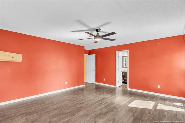 unfurnished room featuring ceiling fan, a textured ceiling, baseboards, and wood finished floors