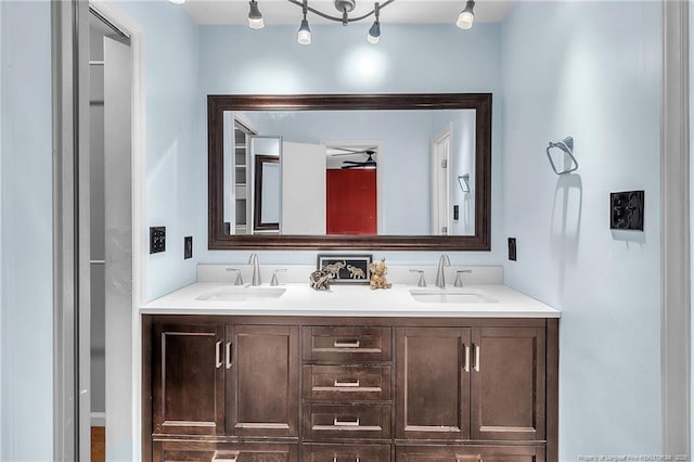 full bathroom featuring ceiling fan, double vanity, and a sink