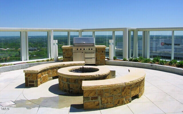 view of patio / terrace featuring a grill and a fire pit