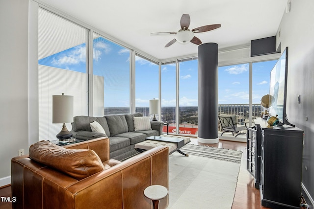 sunroom / solarium featuring a ceiling fan