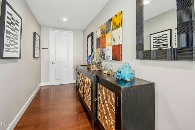 hall featuring recessed lighting, wood finished floors, and baseboards