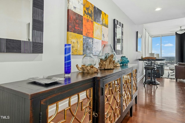 hall featuring a wall of windows, recessed lighting, wood finished floors, and baseboards