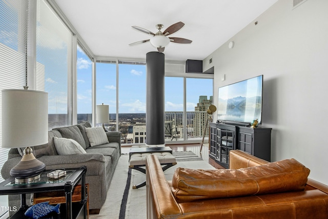 living area with ceiling fan and floor to ceiling windows