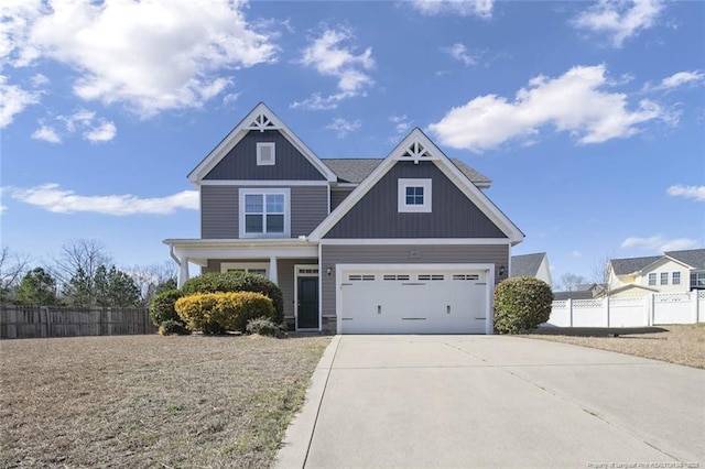 craftsman inspired home with concrete driveway and fence