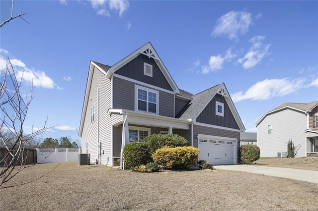 craftsman-style home with central AC, fence, driveway, a gate, and board and batten siding