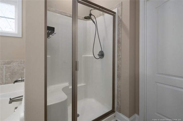 full bath with a shower stall