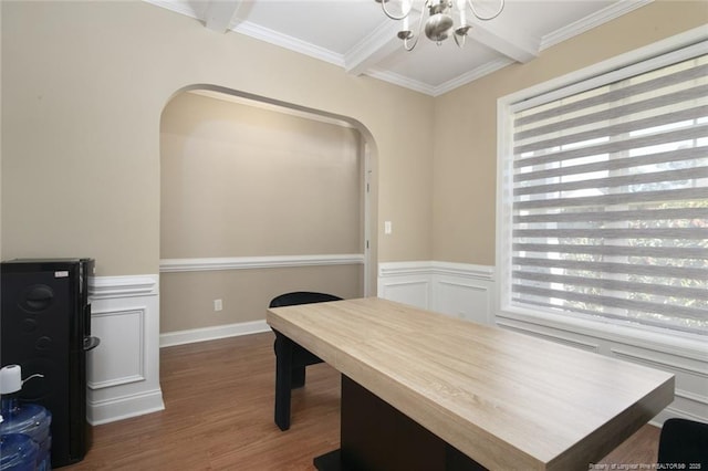 office area with ornamental molding, plenty of natural light, wood finished floors, and beam ceiling