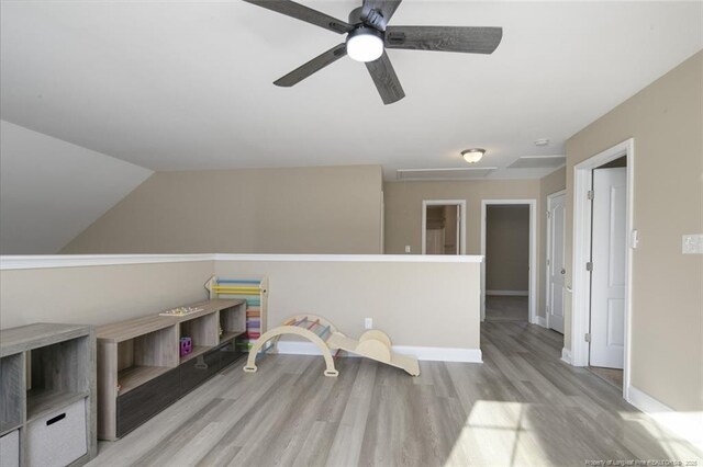 rec room featuring vaulted ceiling, baseboards, and wood finished floors