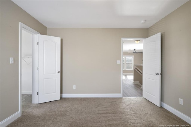 unfurnished bedroom with carpet and baseboards