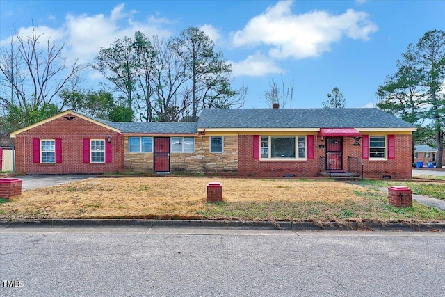 single story home with stone siding, crawl space, brick siding, and a front lawn