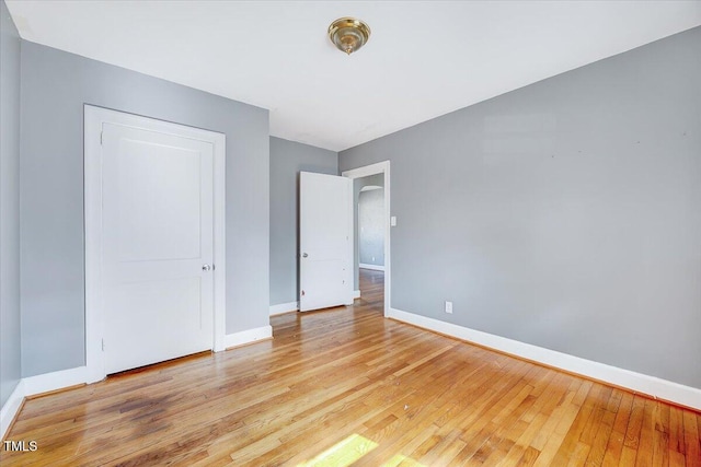 unfurnished bedroom with light wood-style floors and baseboards