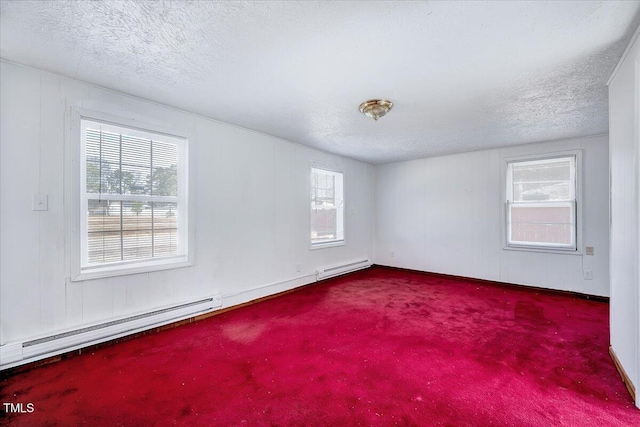 carpeted empty room with a textured ceiling and baseboard heating