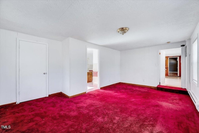 carpeted empty room with a textured ceiling